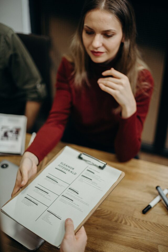 Professional reviewing resume in financial services interview, Ramax Search and Staffing
