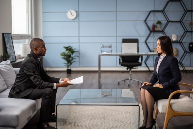 Professional interview conversation in financial services office, Ramax Search and Staffing