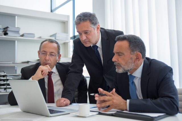 Senior family office executives reviewing CFO search criteria with Ramax Search and Staffing