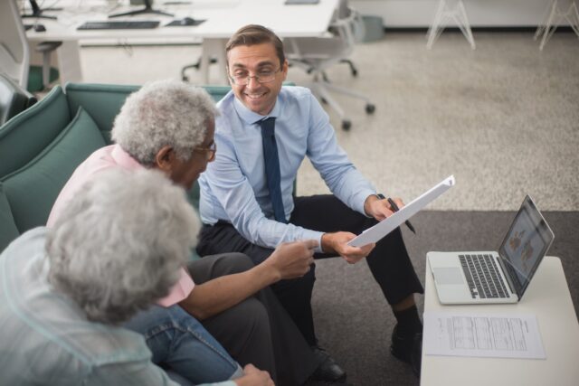Wealth advisor reviewing portfolio with clients, Ramax Search and Staffing