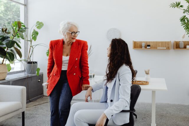 Senior leader mentoring a junior colleague in financial services, Ramax Search and Staffing