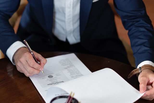 Signing paperwork to bring compliance leadership in house, Ramax Search and Staffing